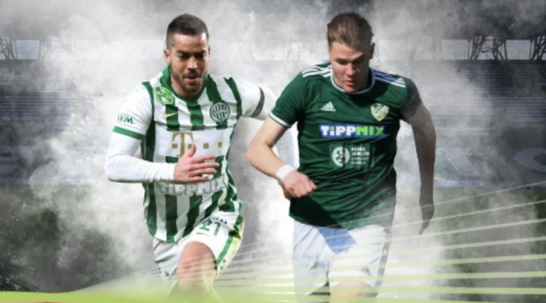 Two soccer players in green jerseys sprint side by side on a stadium field, surrounded by smoky atmosphere during a match.